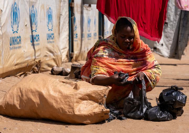 Shaima Ali, a refugee from Sudan selling charcoal outside her home in Renk, South Sudan. 