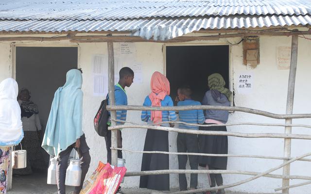Milk suppliers line up at the Andenet (Cheki Andinet) Dairy Cooperative in Debre Birhan, waiting to deliver fresh milk for testing, chilling, and sale.