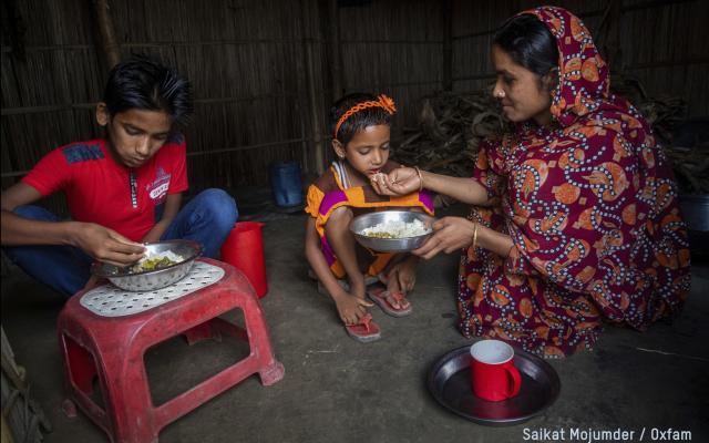 Woman feeds her children 