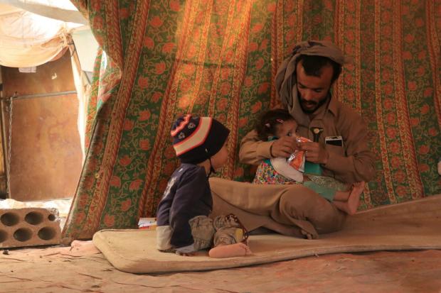 Mofadal with his children inside the camp in Marib.
