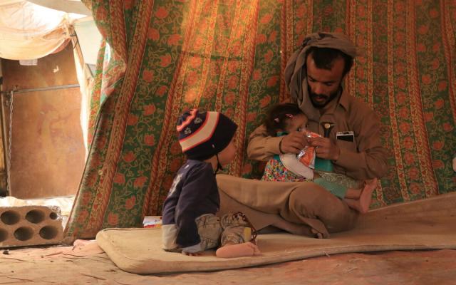 Mofadal with his children inside the camp in Marib.