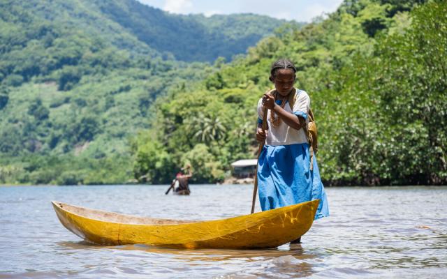 Shirley Ahuia from the Solomon Islands gets ready to go to school in her dug-out canoe.