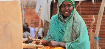 A woman collects water from an Oxfam-constructed water tank in Beledweyne, Somalia.