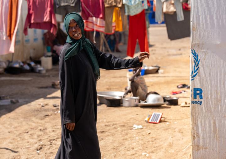 Nadia Zahad, a refugee from the Sudan war stands outside her makeshift home in Renk, South Sudan. 