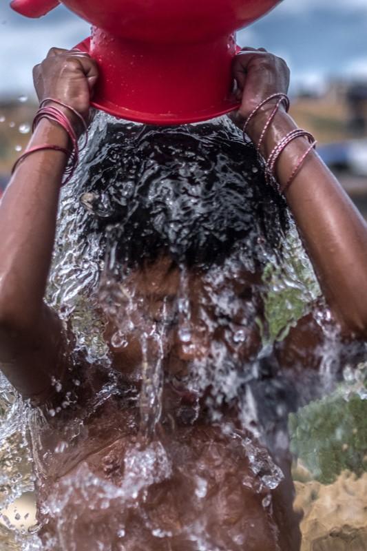 Sofia washes with an Oxfam pump